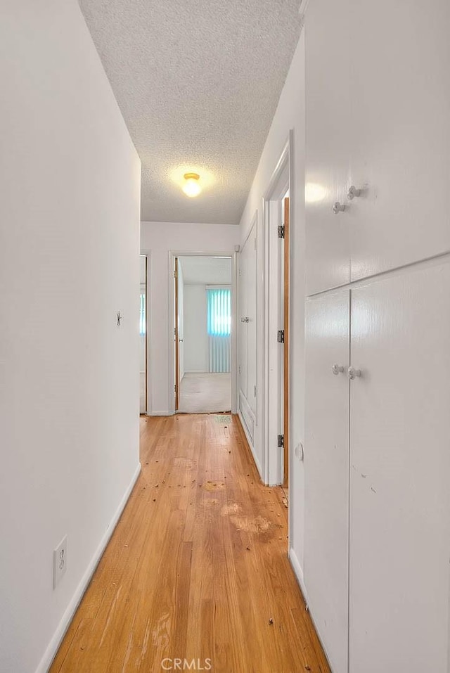 902 W Lucille Ave, West Covina, CA 91790 - corridor featuring light wood finished floors and a textured ceiling