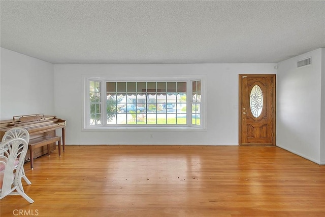902 W Lucille Ave, West Covina, CA 91790 - entryway featuring light wood finished floors and a textured ceiling