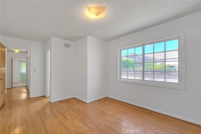 902 W Lucille Ave, West Covina, CA 91790 - unfurnished room featuring light wood-style flooring and a textured ceiling