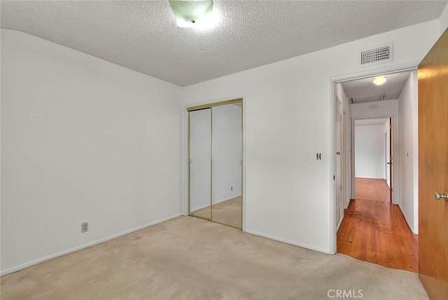 902 W Lucille Ave, West Covina, CA 91790 - unfurnished bedroom with a closet, carpet floors, and a textured ceiling