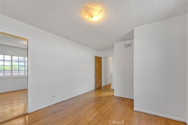 902 W Lucille Ave, West Covina, CA 91790 - unfurnished room with wood finished floors and a textured ceiling