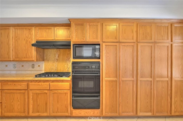 902 W Lucille Ave, West Covina, CA 91790 - kitchen with black appliances, a warming drawer, under cabinet range hood, light countertops, and tasteful backsplash