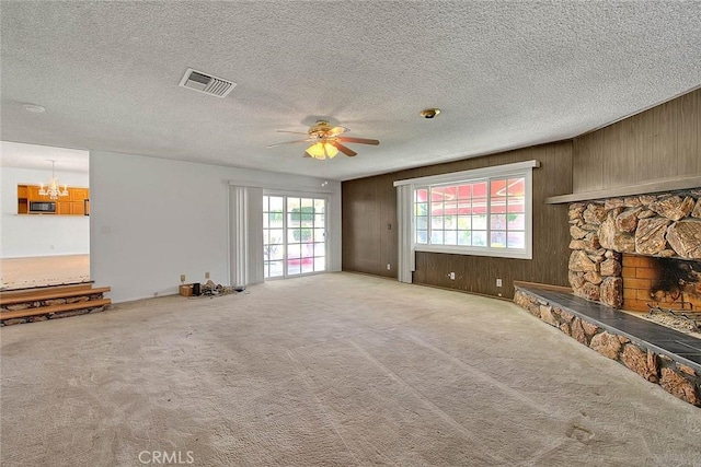 902 W Lucille Ave, West Covina, CA 91790 - unfurnished living room with a ceiling fan, a fireplace, a chandelier, carpet flooring, and a textured ceiling