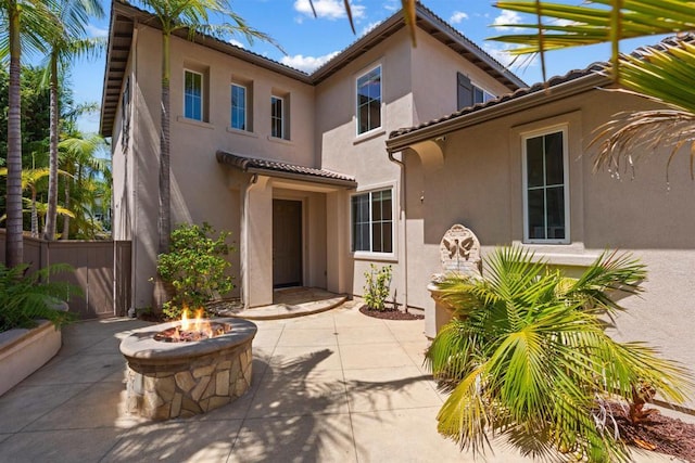 3463 Corte Fresa, Carlsbad, CA 92009 - back of property featuring a patio, stucco siding, a tiled roof, and an outdoor fire pit