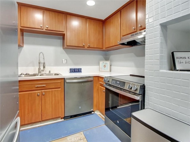 3010 Associated Rd Unit 133, Fullerton, CA 92835 - kitchen featuring appliances with stainless steel finishes, under cabinet range hood, light countertops, and brown cabinets