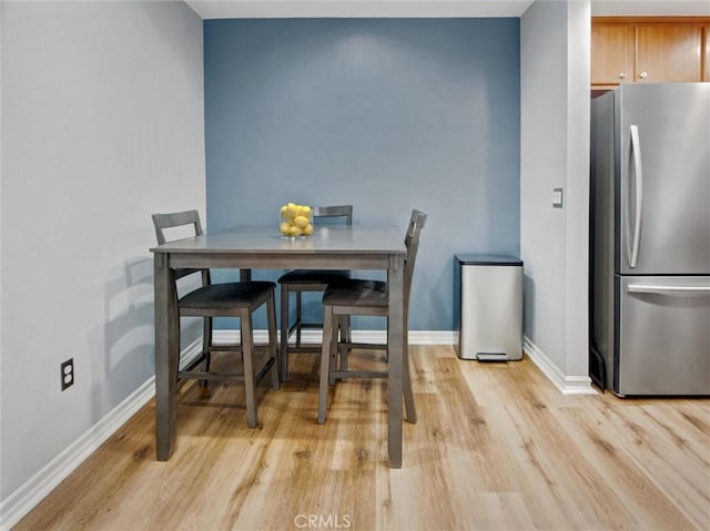 3010 Associated Rd Unit 133, Fullerton, CA 92835 - dining space with light wood-style floors