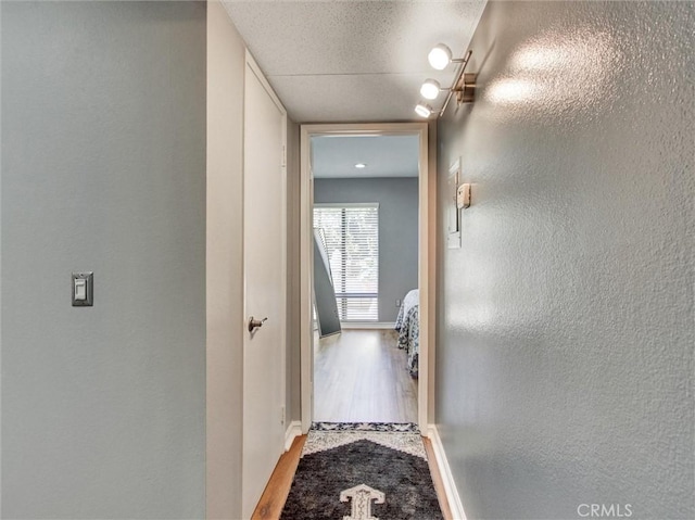 3010 Associated Rd Unit 133, Fullerton, CA 92835 - corridor with wood finished floors and a textured wall
