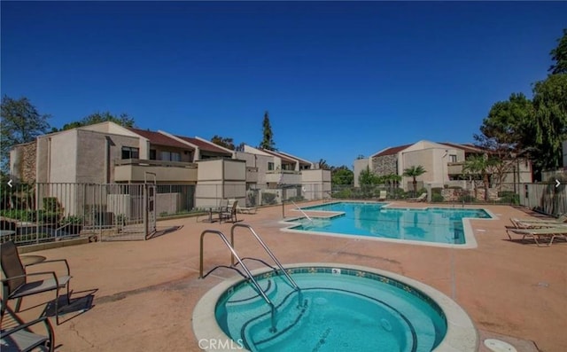 3010 Associated Rd Unit 133, Fullerton, CA 92835 - community pool featuring a hot tub, a patio, and a residential view