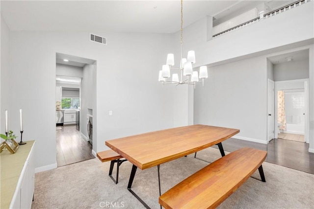7133 Brisas Ct, Rancho Cucamonga, CA 91739 - carpeted dining room with a chandelier and wood finished floors