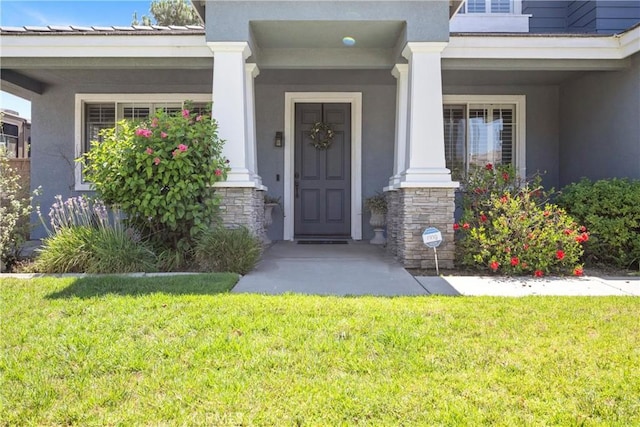 7133 Brisas Ct, Rancho Cucamonga, CA 91739 - entrance to property featuring stucco siding, a lawn, stone siding, and covered porch
