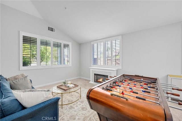 7133 Brisas Ct, Rancho Cucamonga, CA 91739 - recreation room with carpet flooring, vaulted ceiling, and a glass covered fireplace