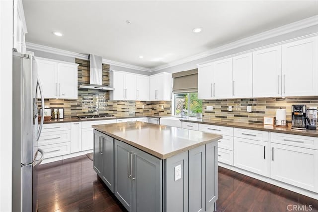 7133 Brisas Ct, Rancho Cucamonga, CA 91739 - kitchen featuring wall chimney exhaust hood, appliances with stainless steel finishes, gray cabinetry, dark wood-type flooring, and tasteful backsplash