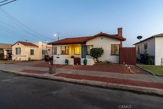 1417 Highland Ave, Needles, CA 92363 - mediterranean / spanish-style home with a tiled roof, stucco siding, and a chimney