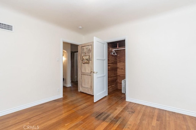 1417 Highland Ave, Needles, CA 92363 - unfurnished bedroom with light wood-type flooring and arched walkways
