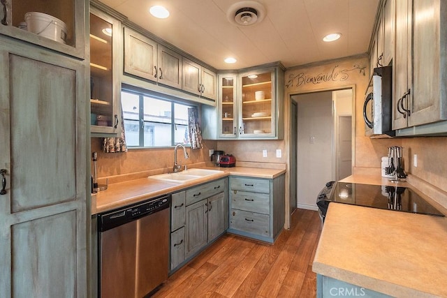 1417 Highland Ave, Needles, CA 92363 - kitchen featuring appliances with stainless steel finishes, light wood finished floors, light countertops, glass insert cabinets, and recessed lighting