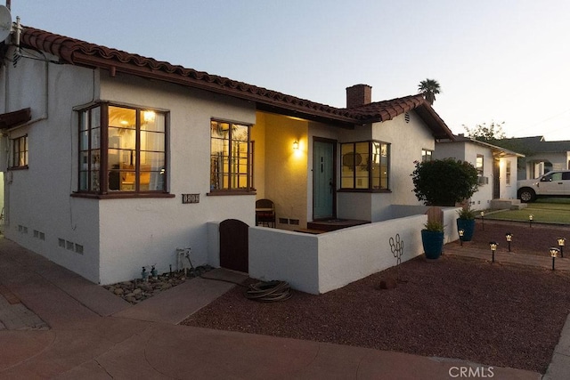 1417 Highland Ave, Needles, CA 92363 - mediterranean / spanish-style house featuring a chimney, stucco siding, and a tile roof