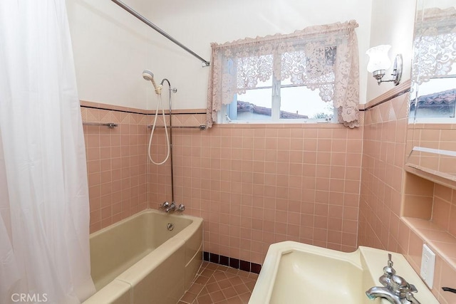 1417 Highland Ave, Needles, CA 92363 - full bath with tile walls, healthy amount of natural light, shower / bath combination with curtain, tile patterned flooring, and wainscoting