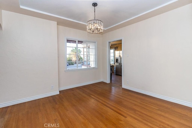 1417 Highland Ave, Needles, CA 92363 - empty room with wood finished floors, a chandelier, and ornamental molding