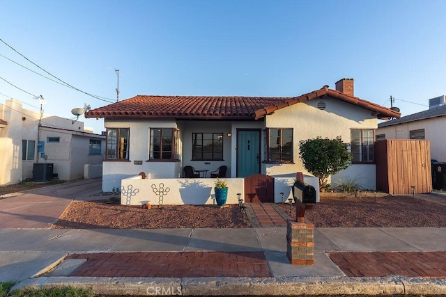 1417 Highland Ave, Needles, CA 92363 - mediterranean / spanish home with stucco siding, a tile roof, and a chimney