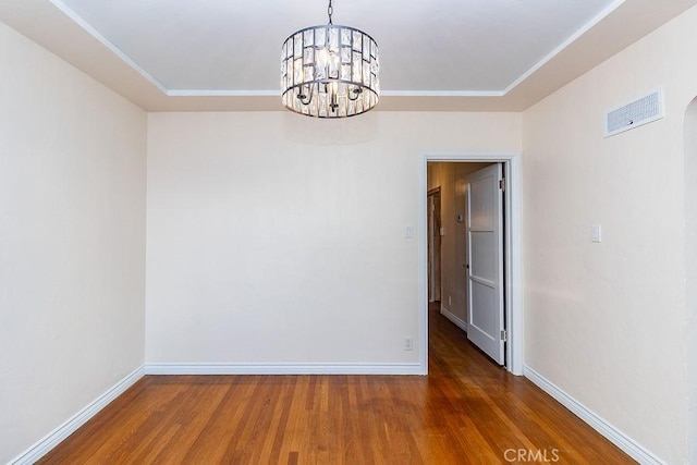 1417 Highland Ave, Needles, CA 92363 - spare room with wood finished floors, a chandelier, and crown molding