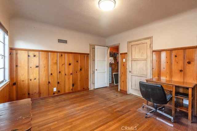 1417 Highland Ave, Needles, CA 92363 - home office with wood finished floors, a wainscoted wall, and wood walls