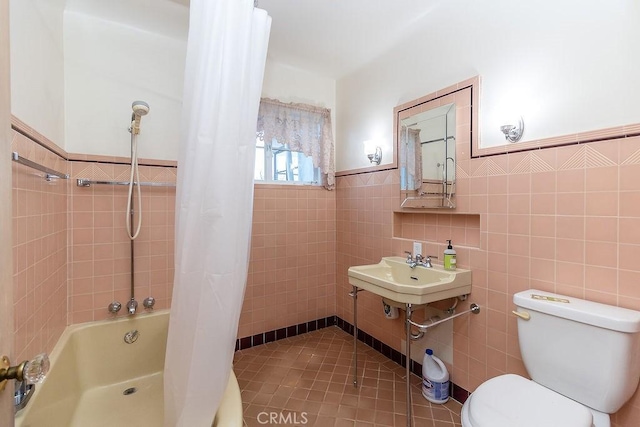 1417 Highland Ave, Needles, CA 92363 - bathroom with tiled shower, tile walls, a wainscoted wall, and tile patterned floors