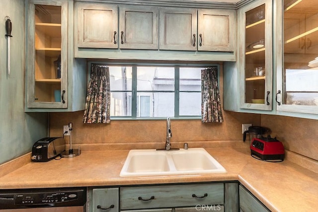 1417 Highland Ave, Needles, CA 92363 - kitchen featuring dishwasher, light countertops, gray cabinets, and glass insert cabinets