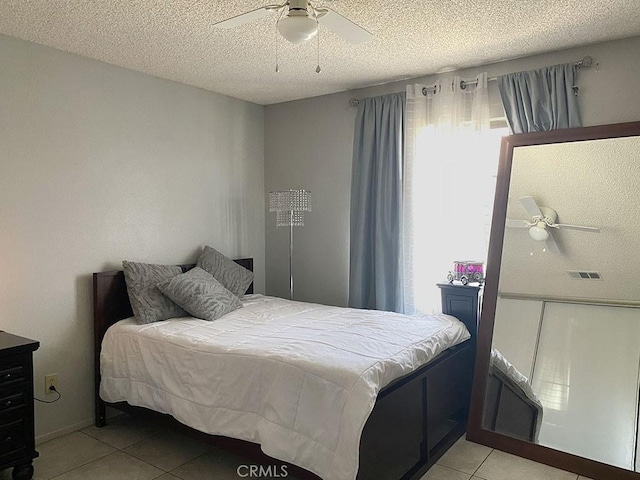 813 Cortez Dr, Hemet, CA 92545 - bedroom featuring light tile patterned flooring, ceiling fan, and a textured ceiling
