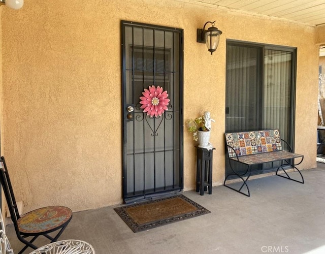 813 Cortez Dr, Hemet, CA 92545 - entrance to property featuring covered porch and stucco siding