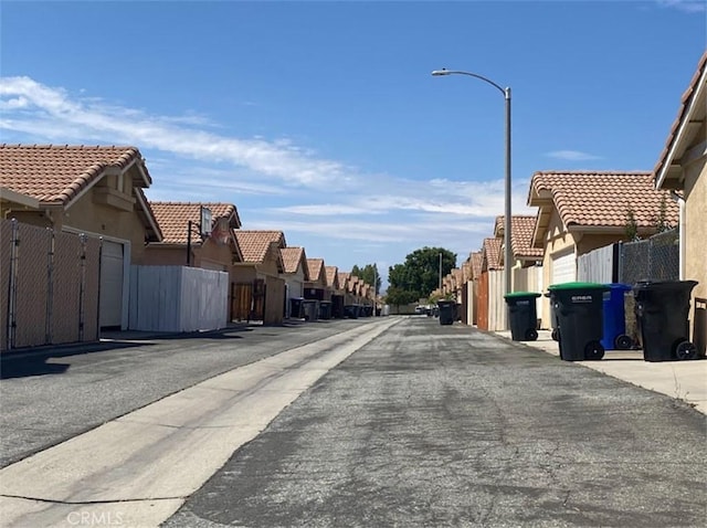 813 Cortez Dr, Hemet, CA 92545 - view of asphalt road with a residential view and street lights