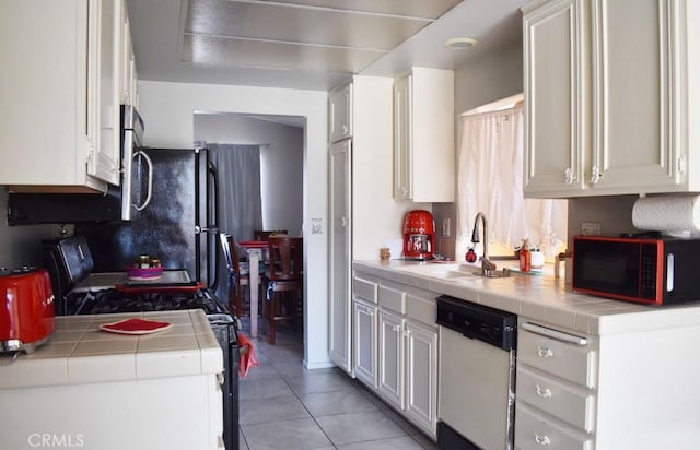 813 Cortez Dr, Hemet, CA 92545 - kitchen featuring dishwasher, tile counters, light tile patterned floors, stainless steel microwave, and white cabinetry