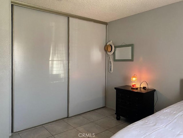 813 Cortez Dr, Hemet, CA 92545 - bedroom featuring a textured ceiling, light tile patterned floors, and a closet