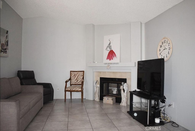 813 Cortez Dr, Hemet, CA 92545 - living area featuring a tiled fireplace, a textured ceiling, and tile patterned flooring