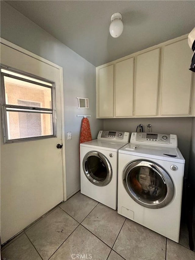813 Cortez Dr, Hemet, CA 92545 - laundry room with cabinet space, washer and clothes dryer, and light tile patterned flooring