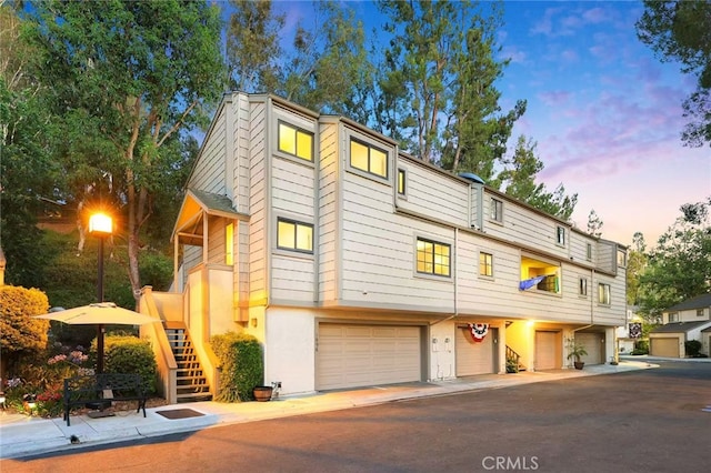 1696 Shady Brook Dr Unit 14, Fullerton, CA 92831 - view of front of house featuring a garage, stairway, and stucco siding