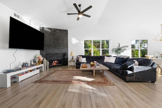 2027 Jenna Pl, Escondido, CA 92029 - living area with ceiling fan, wood finished floors, lofted ceiling, a fireplace, and a chandelier