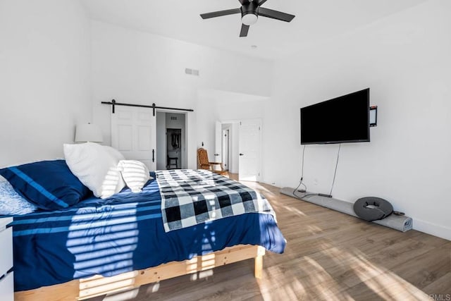 2027 Jenna Pl, Escondido, CA 92029 - bedroom featuring wood finished floors, lofted ceiling, a ceiling fan, and a barn door