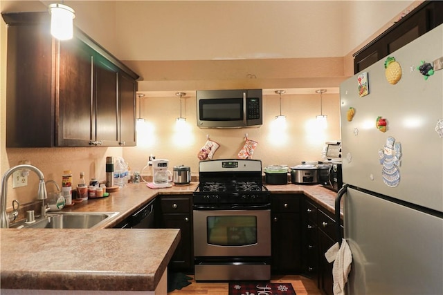 13135 Sunnybrook Cir Unit 205, Garden Grove, CA 92844 - kitchen featuring appliances with stainless steel finishes, a peninsula, light countertops, and pendant lighting