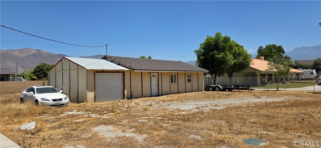 1131 E Evans St, San Jacinto, CA 92583 - view of home's exterior with a mountain view and board and batten siding