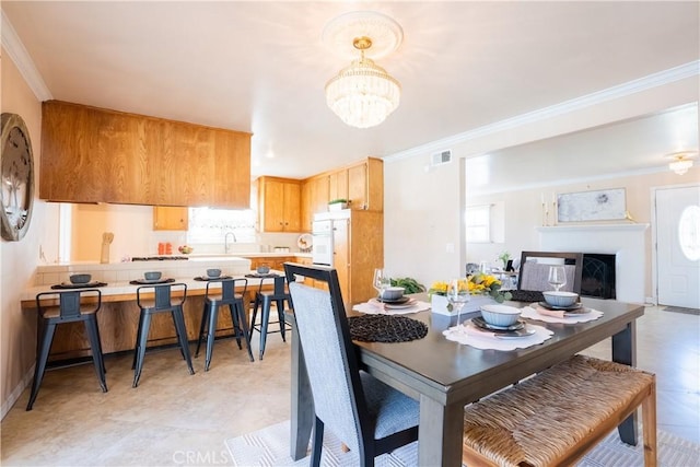 3730 E Euclid Ave, Orange, CA 92869 - dining room with a chandelier, plenty of natural light, crown molding, and a fireplace