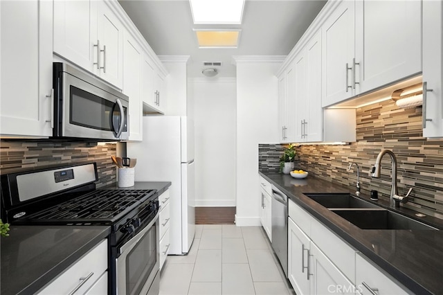 12001 Goshen Ave Unit 303, Los Angeles, CA 90049 - kitchen with appliances with stainless steel finishes, tasteful backsplash, white cabinets, and light tile patterned floors