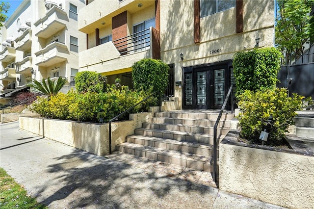 12001 Goshen Ave Unit 303, Los Angeles, CA 90049 - view of exterior entry featuring french doors and stucco siding