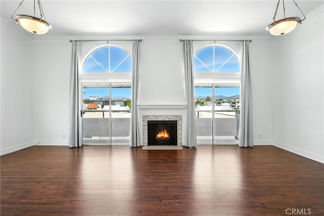 12001 Goshen Ave Unit 303, Los Angeles, CA 90049 - unfurnished living room with wood finished floors, a stone fireplace, and crown molding