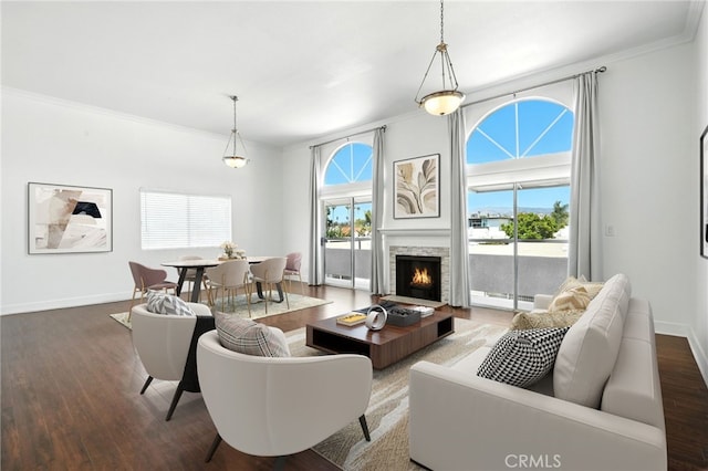 12001 Goshen Ave Unit 303, Los Angeles, CA 90049 - living room featuring ornamental molding, plenty of natural light, wood finished floors, a fireplace with flush hearth, and a baseboard radiator