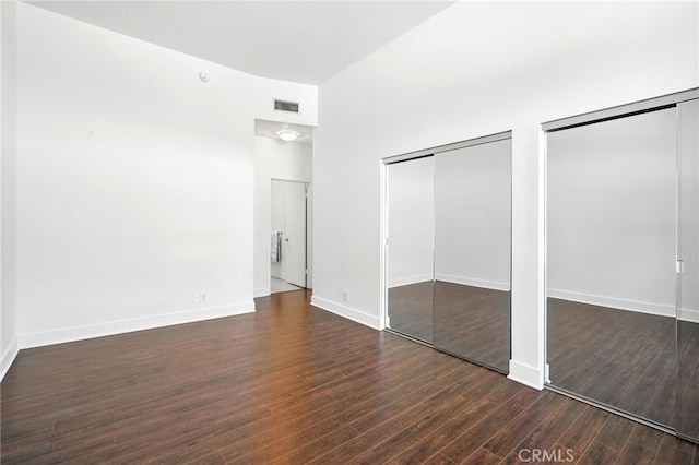12001 Goshen Ave Unit 303, Los Angeles, CA 90049 - unfurnished bedroom with two closets and dark wood-style floors