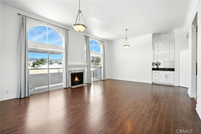 12001 Goshen Ave Unit 303, Los Angeles, CA 90049 - unfurnished living room with crown molding, dark wood finished floors, and a fireplace with flush hearth