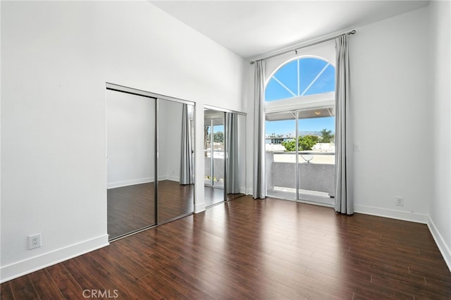 12001 Goshen Ave Unit 303, Los Angeles, CA 90049 - unfurnished bedroom with access to outside, wood finished floors, and a high ceiling