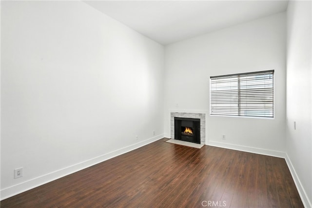 12001 Goshen Ave Unit 303, Los Angeles, CA 90049 - unfurnished living room featuring dark wood finished floors and a fireplace with flush hearth