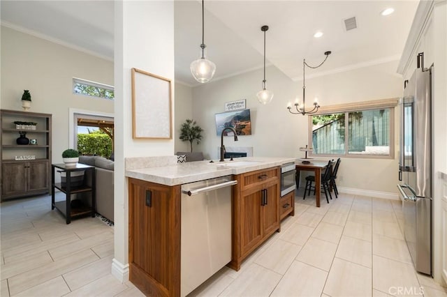 2666 Peacock Pl, La Verne, CA 91750 - kitchen with stainless steel appliances, brown cabinets, ornamental molding, decorative light fixtures, and a chandelier