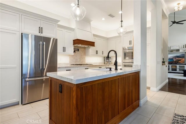 2666 Peacock Pl, La Verne, CA 91750 - kitchen featuring appliances with stainless steel finishes, backsplash, light stone countertops, crown molding, and ceiling fan